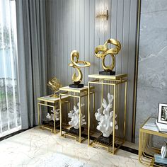 three gold and white vases sitting next to each other in front of a window