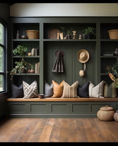 a room filled with lots of different types of pillows and hats on the wall next to a window