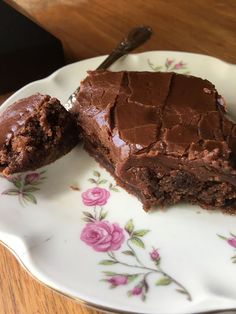 a piece of chocolate cake sitting on top of a plate with a bite taken out of it