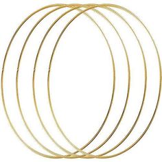 four gold colored metal hoops on a white background with clipping for text or image