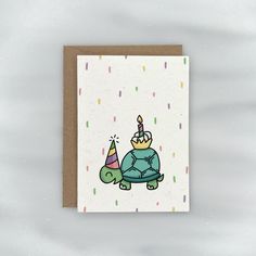 a card with a turtle wearing a birthday hat