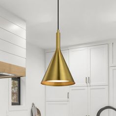 a kitchen with white cabinets and gold pendant light hanging from the ceiling over the sink