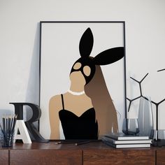 an art piece with a woman's face in the shape of a rabbit on top of a dresser