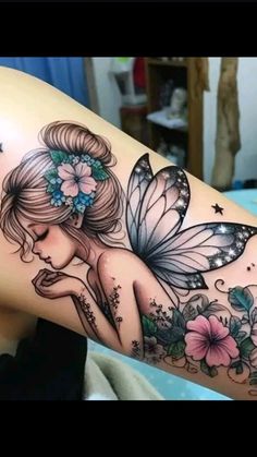 a woman's arm with a flower and butterfly tattoo on the back of her leg