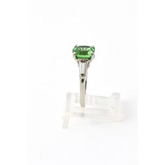 Stunning GIA certed natural Tsavorite Garnet mounted in a simple tapered baguette diamond and platinum mounting.  The 2.78 carat tsavorite  2.78 is an gorgeous green transparent color.    US size 4.5.  It can be sized.  The ring measures .66" wide by .33" tall. Gia Certified Green Tsavorite Rings, Green Tsavorite Rings With Round Cut, Platinum Diamond Rings, Tsavorite Garnet, Platinum Ring, Baguette Diamond, Garnet, Platinum, Ring Size