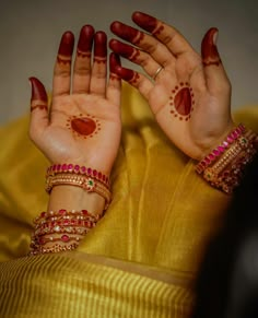 a woman's hands with hendi tattoos on them