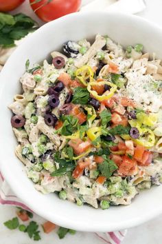 a white bowl filled with pasta salad on top of a table