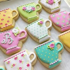 decorated cookies in the shape of tea cups and kettles