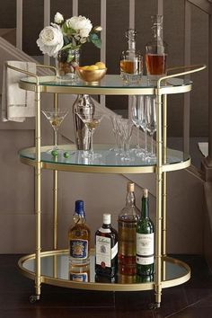 a bar cart with liquor bottles and glasses on it for $ 699 99 in store