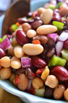 a blue bowl filled with beans and onions