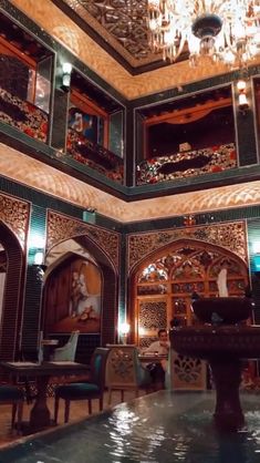 an ornately decorated room with chandeliers and tables