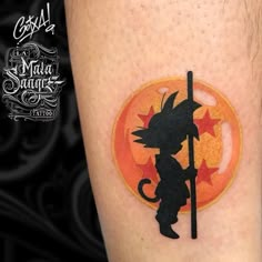 a tattoo on the leg of a person with a cat holding a broom and stars