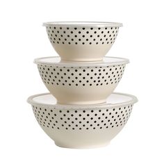 three bowls stacked on top of each other with polka dot design in white and black