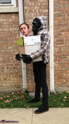 a man dressed as a gorilla holding a box with the words halloween costume contest on it