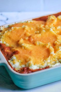 a casserole dish with cheese and meat in it