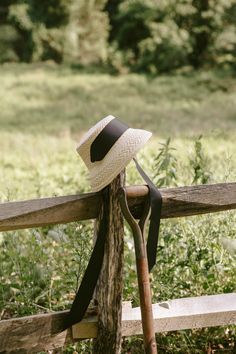 a hat is tied to the back of a wooden bench