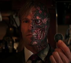 a man in a suit and tie holding a spoon with his face painted like a zombie