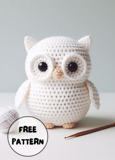 crocheted owl with glasses and knitting needles next to it