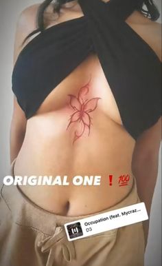 a woman's stomach with a flower tattoo on the top and bottom part of her body