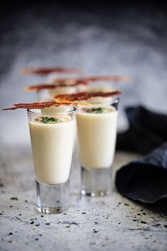 three glasses filled with food sitting on top of a table