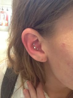 a close up of a person with a piercing in their ear