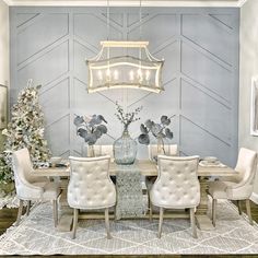 the dining room is decorated for christmas with white chairs