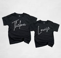 Custom handmade Thelma and Louise youth t-shirts. Available in youth, toddler, and baby sizes. Perfect for friends, siblings, mom and daughters, and all the duos in between! sweatshirts are available in some sizes. Please send a message if you would like a sweatshirt. H O W T O O R D E R Y O U R S H I R T : At checkout, please select the size you want, add to your cart, and then checkout through Etsy. If the size you want isn't in stock, I will message you right away and there will be a 2-3 day Black Unisex T-shirt For Family Occasions, Cute Black Tops With Custom Print, Cute Black Top With Custom Print, Custom Print Black Tops For Family Occasions, Casual Personalized Short Sleeve Tops, Personalized Casual Short Sleeve Tops, Family Matching Custom Name Cotton T-shirt, Custom Name Cotton T-shirt For Family Matching, Family Matching Cotton T-shirt With Custom Name