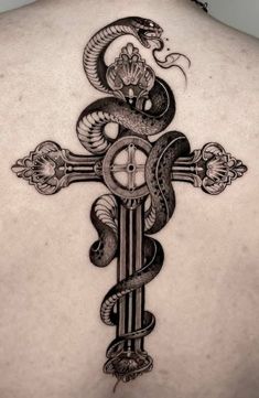 the back of a person with a cross and snake on it