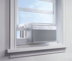 an air conditioner sitting on top of a window sill