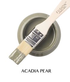 a paintbrush with the words acadia pear on it next to a green bowl