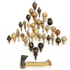 an assortment of wooden objects are arranged in the shape of a christmas tree with a hammer