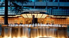 the entrance to villa madam hotel in new york city, ny at night with water fountains