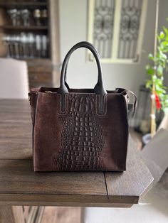 The Mia Special Edition tote bag is a super leather handbag for all occasions. Stylish, practical, and spacious, it is a great option for daytime as well as for an elegant evening out. Mia is hand-crafted in Florence from Italian pebbled calf leather, with a printed crocodile exterior design. This special edition bag comes in a rich, luxurious brown suede only and is the perfect summer evening, fall or winter handbag companion. This special edition handbag features an interior zipped liner that Leather Satchel With Crocodile Pattern, Luxury Crocodile Pattern Satchel For Everyday Use, Luxury Everyday Shoulder Bag With Crocodile Pattern, Luxury Crocodile Pattern Everyday Shoulder Bag, Leather Satchel With Crocodile Pattern And Double Handle, Rectangular Leather Bag With Crocodile Pattern, Leather Bags With Crocodile Pattern And Double Handle, Leather Bags With Crocodile Pattern And Rectangular Shape, Leather Satchel With Crocodile Pattern And Top Handle