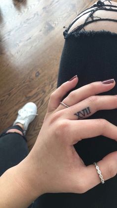 a woman's hand with a ring on her finger and the word iu written in it