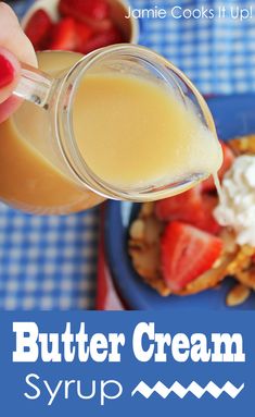 a person is pouring some liquid onto waffles with strawberries on the side