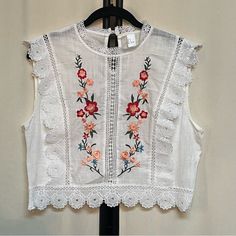 Adorable Designer Women’s Cotton Embroidered Lace Trim Top. White With Embroidered Flowers In Front. Lace Trim. Side Zip. Keyhole Button In Back. 17 Inches Long 19 Inches From Armpit To Armpit Tag Indicates Xl, But Item Runs Small. Note Measurements Above. New Without Tags, Never Worn. White Cotton Tops With Tonal Embroidery, Sleeveless Top With Intricate Embroidery For Spring, Intricate Embroidery Sleeveless Top For Spring, White Cotton Embroidered Top With Tonal Embroidery, White Tops With Tonal Embroidery, White Cotton Tops With Intricate Embroidery, Lace Trim Top, Trim Top, Dress Top