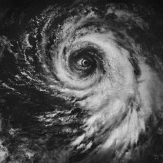 an eye is shown in the center of a black and white photo, with clouds around it