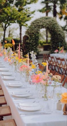 a long table is set with flowers and candles