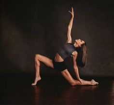 a woman is doing yoga on the floor