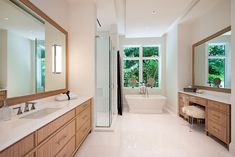 a large bathroom with two sinks and a bathtub