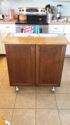 a kitchen island with two cupboards on wheels