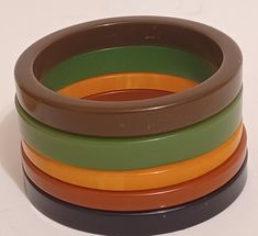 Set of 4 vintage bakelite bracelets in mixed colors green,brown,black, and peach. Unique mixture of bakelite bracelets authentic and tested . Excellent used condition with minimal wear consistent with age and use. Please see all photos. Opening 2.5" approx 1/4" bracelet As The owners of beyond bakelite want you to have the best experience. All items are used and handpicked and thoroughly described with any flaws or condition issues. All items are shipped within 1 to 2 business days and insured. Bakelite Bracelets, Vintage Bakelite, Colors Green, Mixed Colors, Green Brown, Midcentury Modern, Green And Brown, Bangle Bracelets, Color Mixing