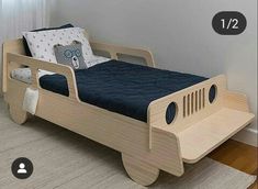 a bed that is made to look like a car with wheels on it and no headboard