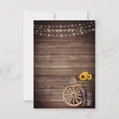 an old fashioned wagon with sunflowers and cowboy boots is displayed on a rustic wood background