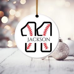 a personalized baseball ornament hanging from a christmas tree