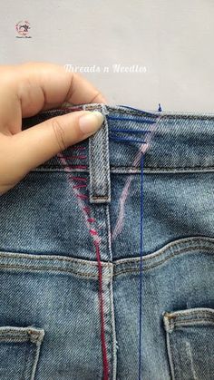 someone is stitching the side of their jeans