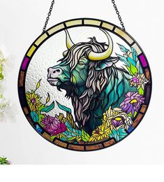 a stained glass window with a bull on it's face and flowers in the background