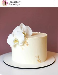 there is a white cake with flowers on it