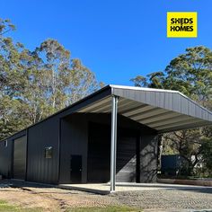 a black building with a yellow sign above it that says sheds homes on the side