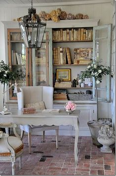 a room filled with lots of books and furniture